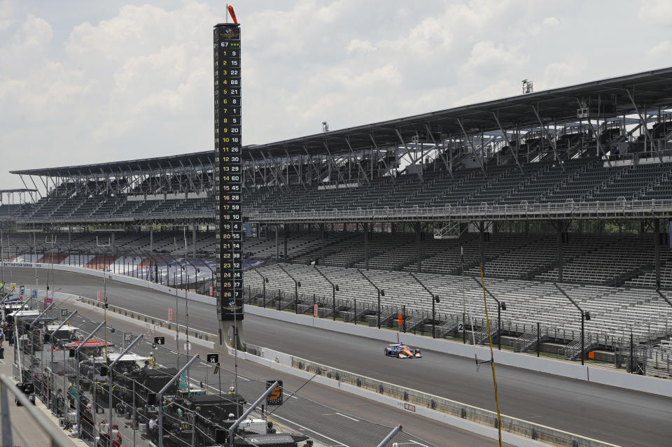 Race driver Scott Dixon, of New Zealand, drives down the main straight in front of empty stands during the IndyCar auto race at Indianapolis Motor Speedway in Indianapolis, Saturday, July 4, 2020. No fans where allowed due to the coronavirus pandemic. (AP Photo/Darron Cummings)