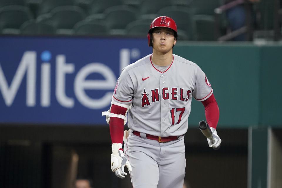 Los Angeles Angels' Shohei Ohtani walks back to the dugout after striking out in the first inning of the team's baseball game against the Texas Rangers in Arlington, Texas, Wednesday, Aug. 4, 2021. (AP Photo/Tony Gutierrez)