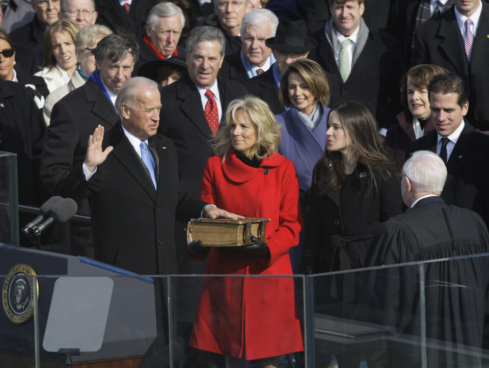 FILE - In this Tuesday, Jan. 20, 2009 file photo, Vice President-elect Joe Biden takes the oath of office from Justice John Paul Stevens as his wife, Jill Biden, holds the Bible at the U.S. Capitol in Washington. While many presidents have used Bibles for their inaugurations, the Constitution does not require the use of a specific text and specifies only the wording of president’s oath. That wording also doesn’t include the phrase “so help me God,” but every modern president has appended it to their oaths and most have chosen symbolically resonant Bibles for their inaugurations. (AP Photo/Elise Amendola)