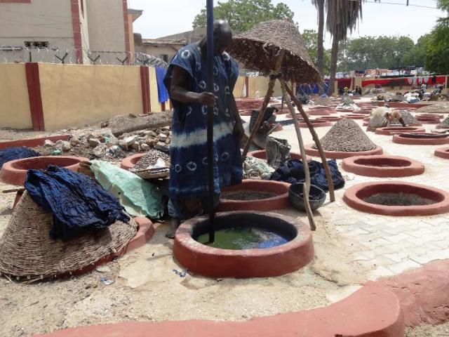 Boy working in the dye pits of Kano Nigeria West Africa Stock