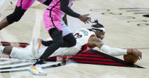 Portland Trail Blazers forward Robert Covington dives for thee ball against the Miami Heat during the second half of an NBA basketball game in Portland, Ore., Sunday, April 11, 2021. (AP Photo/Craig Mitchelldyer)