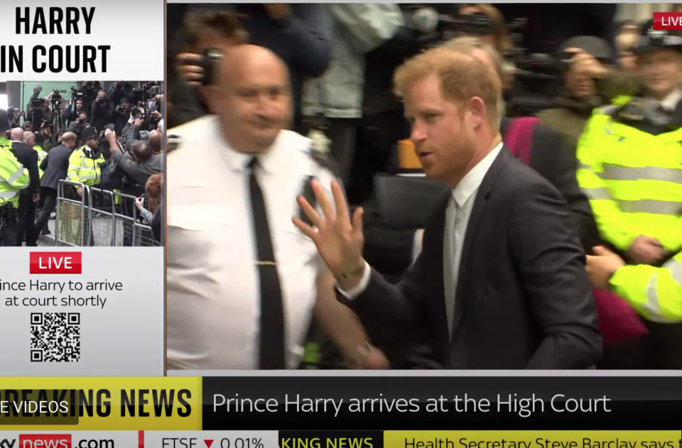 Prince Harry was greeted by a mass of reporters and paparazzi at the High Court (Sky News screengrab)