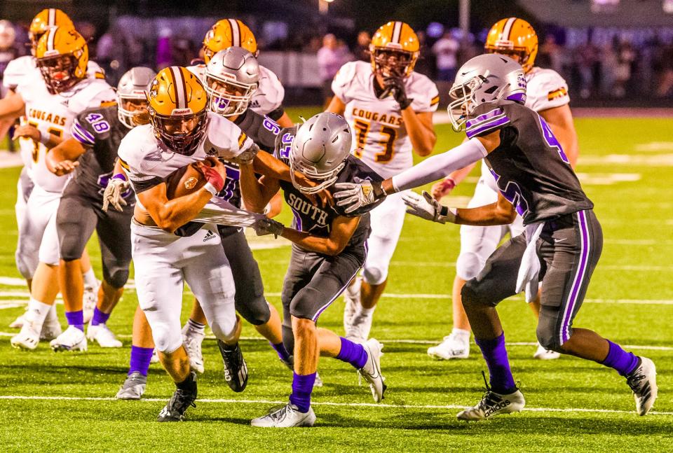 North's Cody Mikulich (10) runs during the Bloomington South versus Bloomington North football game at Bloomington High School South on Friday, September 10, 2021.