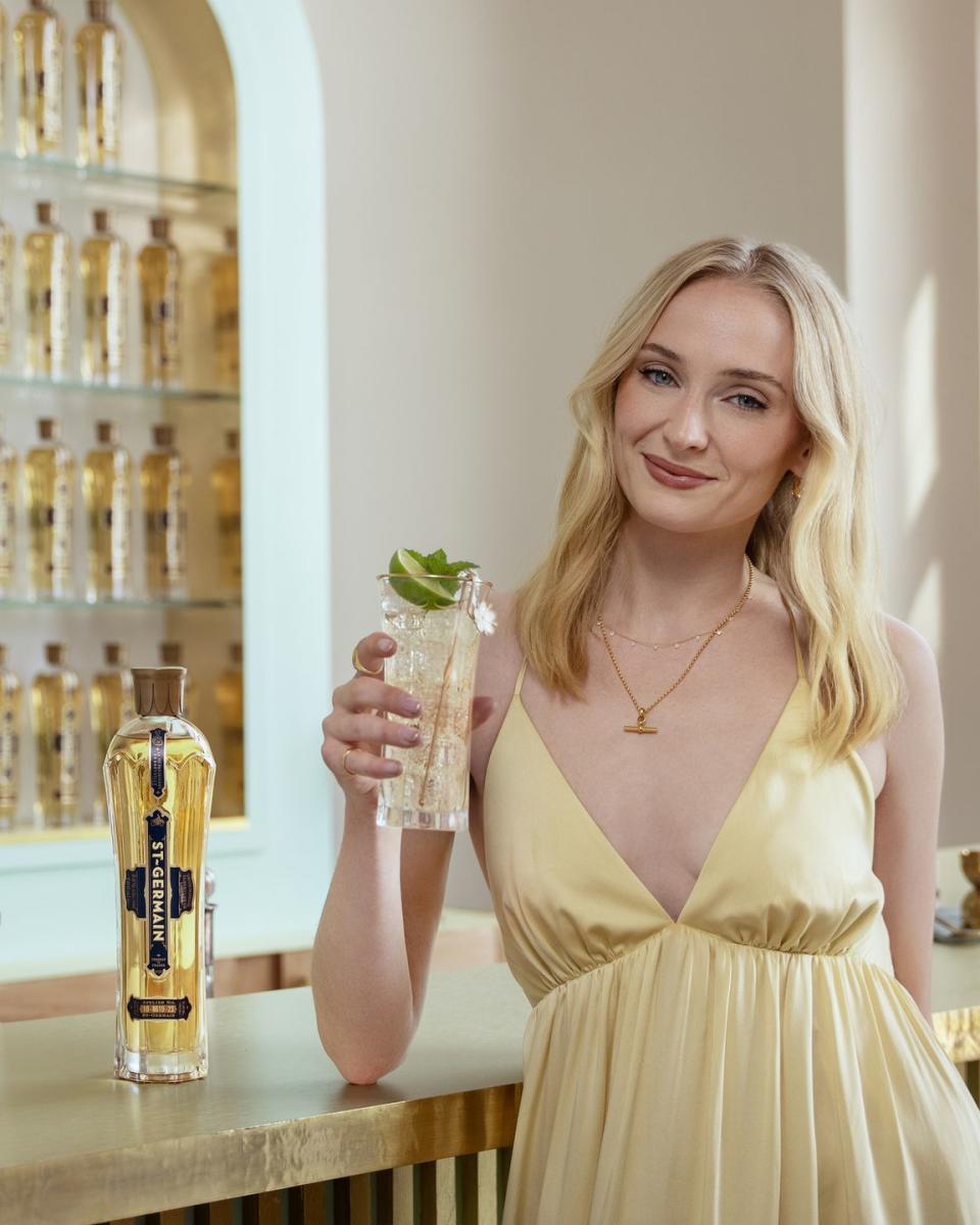 sophie turner holding a drink