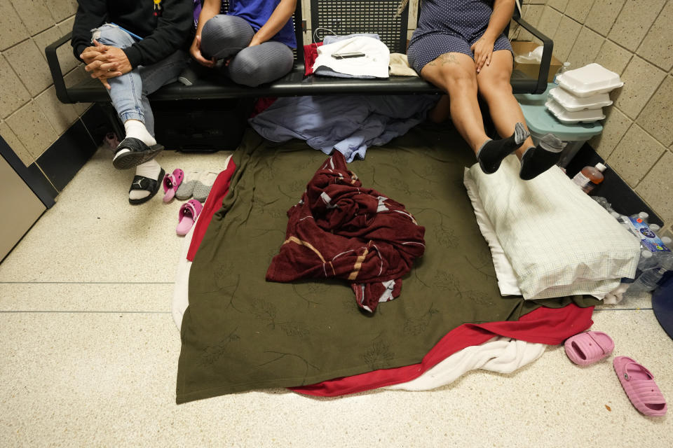 Migrants from Venezuela take shelter in the Chicago Police Department's 16th District station on Monday, May 1, 2023. Chicago has seen the number of new arrivals grow tenfold in recent days. Shelter space is scarce and migrants awaiting a bed are sleeping on floors in police stations and airports. (AP Photo/Charles Rex Arbogast)
