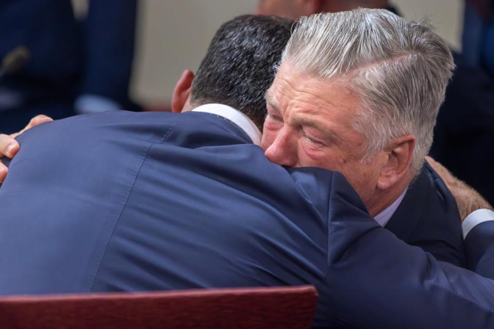 Actor Alec Baldwin, right, hugs his defense attorney Alex Spiro after District Court Judge Mary Marlowe Sommer threw out the involuntary manslaughter case on Friday (AP)