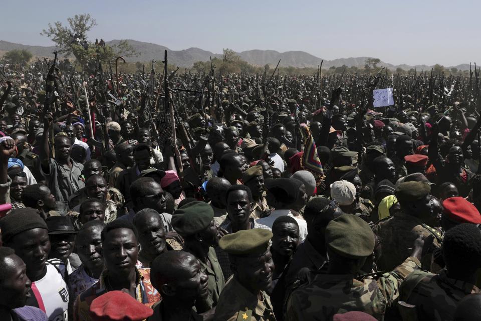 People chant slogans in support of a secular state during a visit organized by The World Food Program (WFP) in the conflict-affected remote town of Kauda, Nuba Mountains, Sudan, Thursday, Jan. 9, 2020. Sudan’s Prime Minister, Abdalla Hamdok, accompanied by United Nations officials, embarked on a peace mission Thursday to Kauda, a rebel stronghold, in a major step toward government efforts to end the country’s long-running civil conflicts. (AP Photo/Nariman El-Mofty)