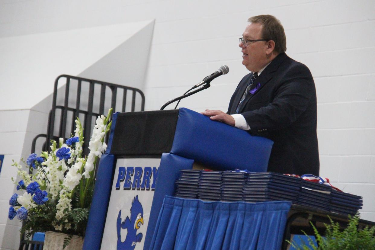 Perry High School Principal Dan Marburger addresses the graduates during the 2021 commencement ceremony. The Perry High School gymnasium court will be renamed the Dan Marburger Court following a school board meeting on Monday, May 13, 2024.