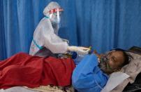 Medical workers treat patients infected with the coronavirus disease (COVID-19) at a hospital in New Delhi