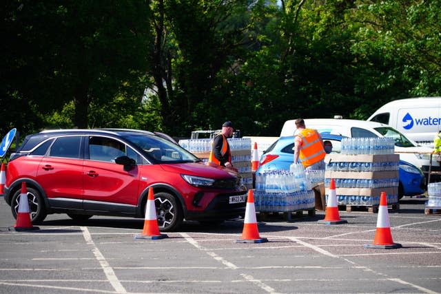 People collecting bottled water