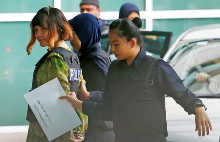 Vietnamese Doan Thi Huong who is on trial for the killing of Kim Jong Nam, the estranged half-brother of North Korea's leader, is escorted as she arrives at the Department of Chemistry in Petaling Jaya, near Kuala Lumpur, Malaysia October 9, 2017. REUTERS/Lai Seng Sin