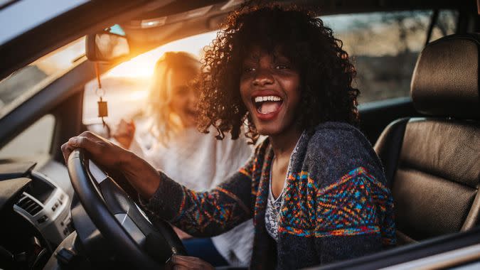 Happy female friends on road trip.