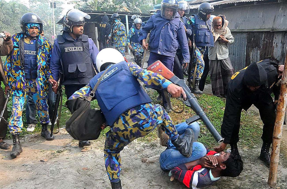 Bangladeshi policemen kick a suspect, following an attack on a polling station, in Bogra, north of Dhaka, Bangladesh, Sunday, Jan. 5, 2014. Police in Bangladesh fired at protesters and more than 100 polling stations were torched in Sunday’s general elections marred by violence and a boycott by the opposition, which dismissed the polls as a farce. (AP Photo)