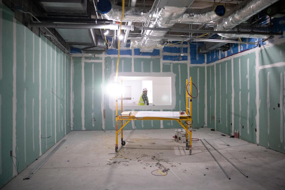 A construction worker walks past the treatment room at the Texas State Aquarium's new Port of Corpus Christi Center for Wildlife Rescue on Jan. 27, 2023, in Corpus Christi, Texas. The room shares a wall with the surgery room. It will be used to to change patients' bandages, administer medication and perform CT scans and X-rays.