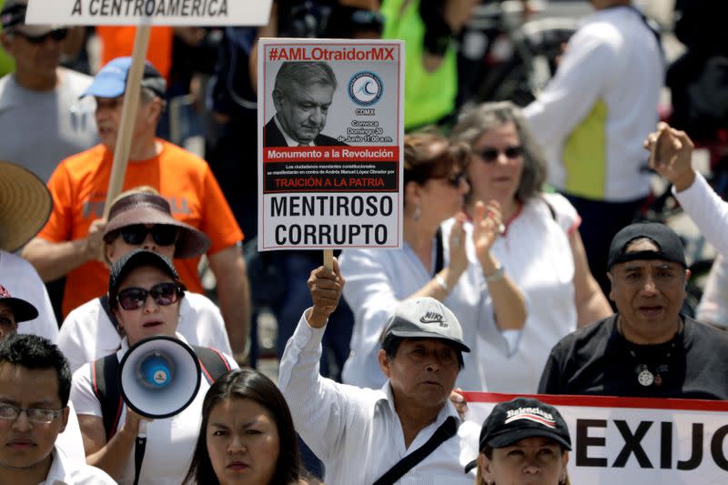 FILE PHOTO: Demonstrators march against Mexico's president Andres Manuel Lopez Obrador a year after his electoral victory in Mexico city