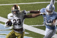 Notre Dame running back Kyren Williams (23) runs while North Carolina linebacker Jeremiah Gemmel (44) misses the tackle during the second half of an NCAA college football game in Chapel Hill, N.C., Friday, Nov. 27, 2020. (AP Photo/Gerry Broome)