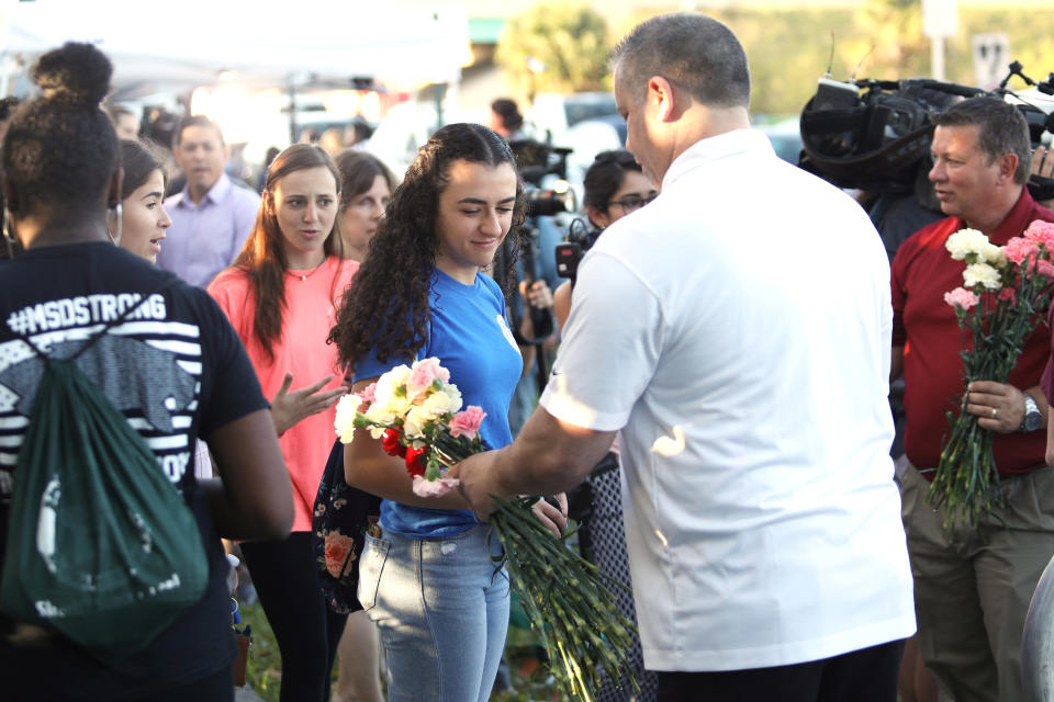 <p>Students receive donated flowers as they arrive at Marjory Stoneman Douglas High School for the first time since the mass shooting in Parkland, Florida, U.S., February 28, 2018. REUTERS/Mary Beth Koeth </p>