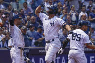 New York Yankees' Giancarlo Stanton, center, celebrates his three-run home run during the third inning of a baseball game against the Oakland Athletics at Yankee Stadium, Wednesday, June 29, 2022, in New York. (AP Photo/Seth Wenig)