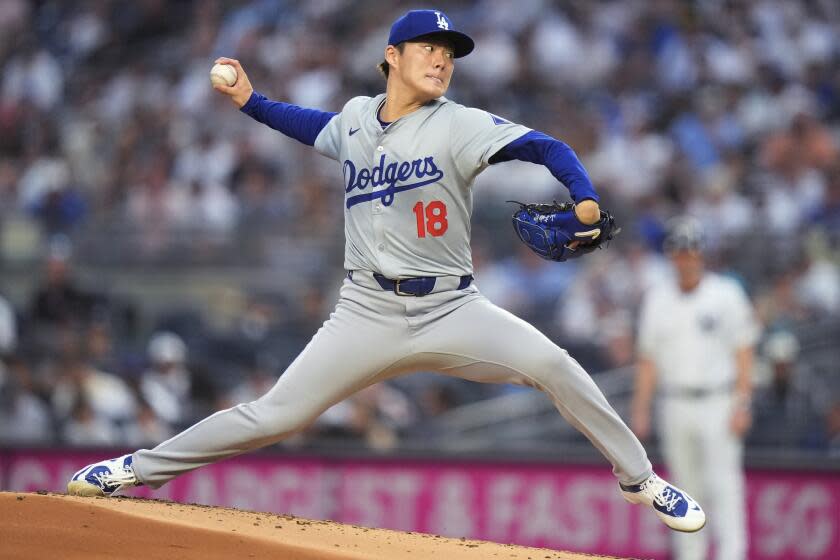 Los Angeles Dodgers' Yoshinobu Yamamoto pitches to a New York Yankees batter.