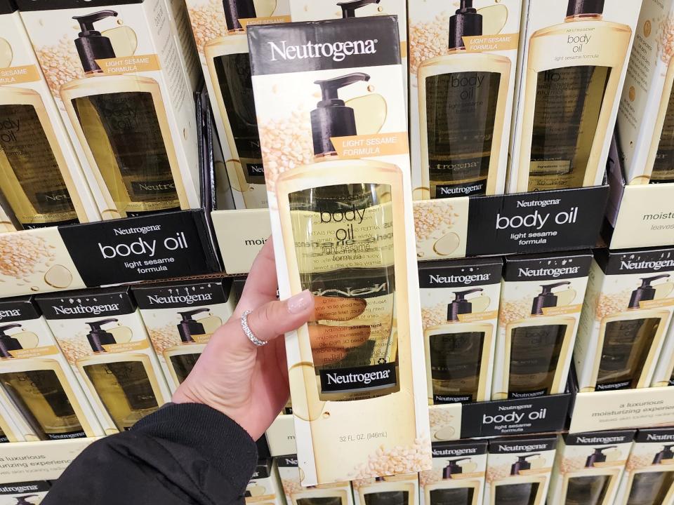 The wrier holds a Neutrogena body oil