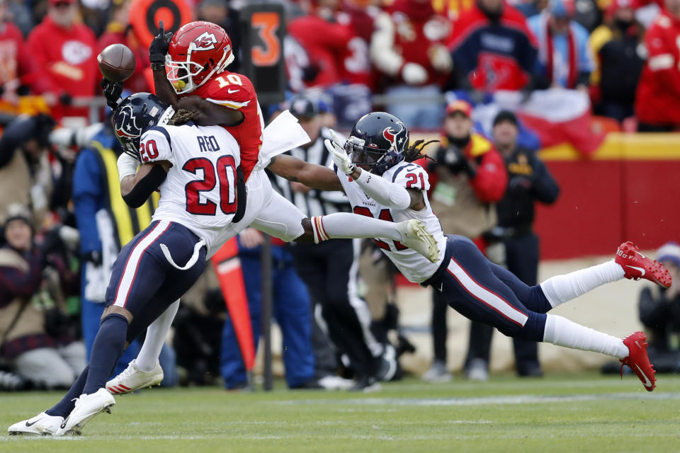 Houston Texans safety Justin Reid (20) and cornerback Bradley Roby (21) break up a pass intended for Kansas City Chiefs wide receiver Tyreek Hill (10) during the first half of an NFL divisional playoff football game, in Kansas City, Mo., Sunday, Jan. 12, 2020. (AP Photo/Jeff Roberson)