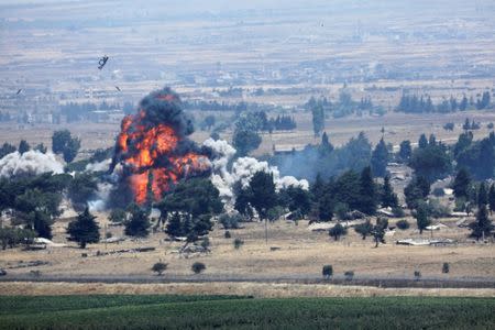 An explosion is seen at Quneitra at the Syrian side of the Israeli Syrian border as it is seen from the Israeli-occupied Golan Heights, Israel July 22, 2018. REUTERS/Ronen Zvulun