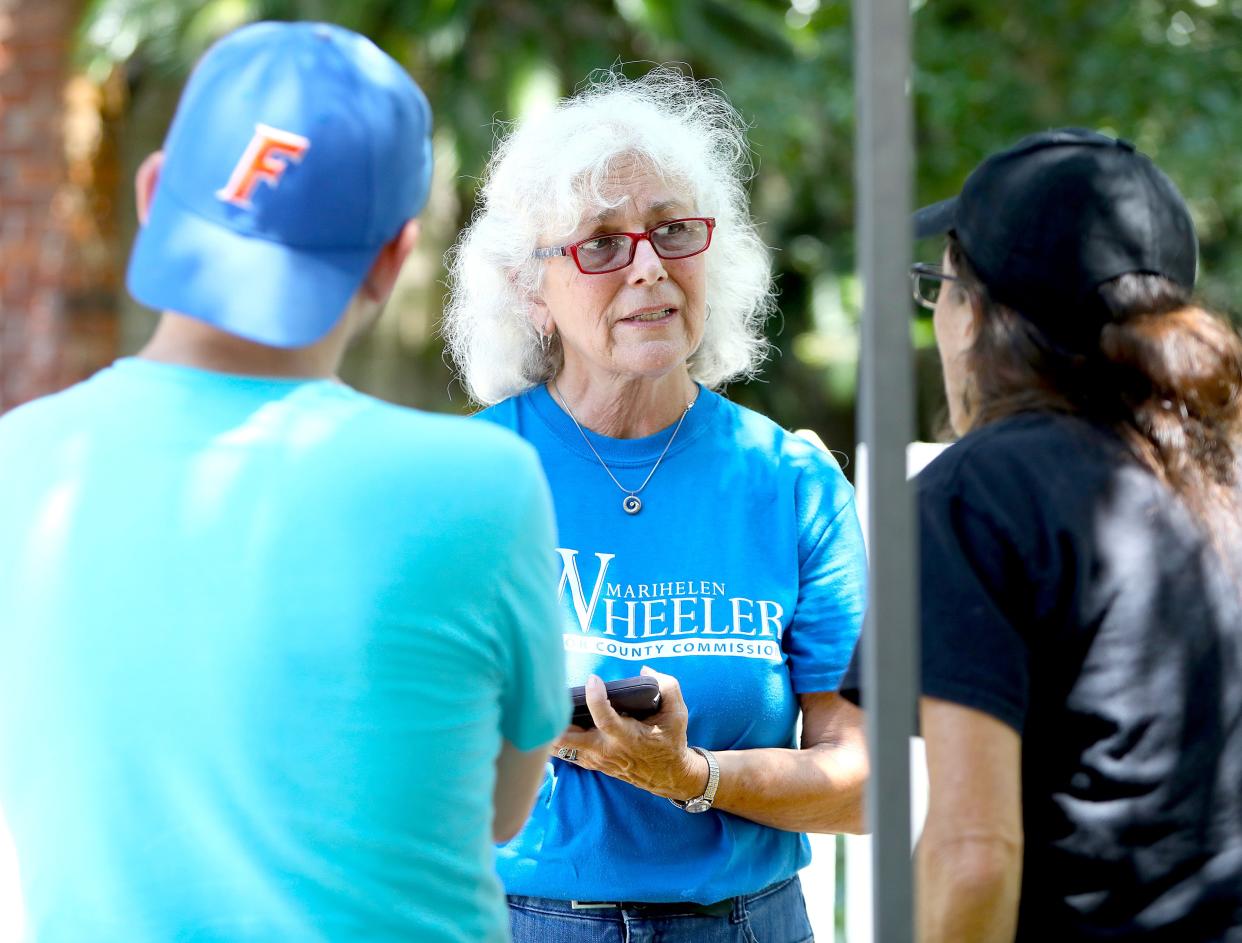 Marihelen Wheeler, a candidate for county commission district 2, talks with a citizen during the Souls to the Polls event, in Gainesville FL. August 14, 2022. The event was to give citizens a chance to meet all the local candidates for political office and then to encourage citizens to vote early.