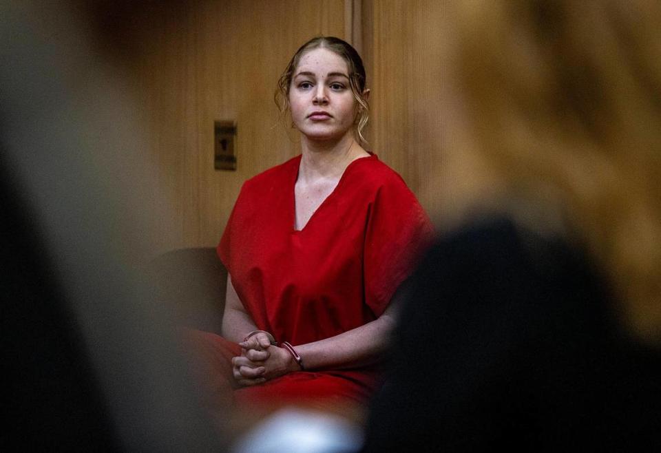 OnlyFans model Courtney Clenney sits in the courtroom during a hearing on Thursday, Dec. 8, before Judge Laura Shearon Cruz ruled she had to remain in jail while awaiting trial. She is accused of murdering her boyfriend Christian Obumsel on April 3 in Miami.