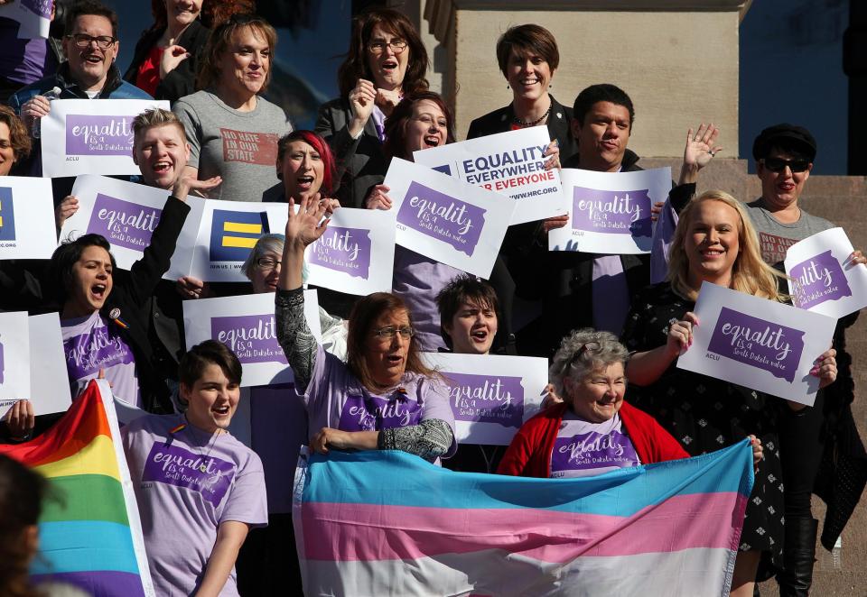 Representatives from the Center for Equality, American Civil Liberties Union of South Dakota, LGBT supporters and members of the Human Rights Campaign stand on the front steps to honor Trans Kids Support Visibility Day at the State Capitol in Pierre, S.D. on Tuesday, Feb. 23, 2016.  (AP Photo / Argus Leader, Jay Pickthorn)