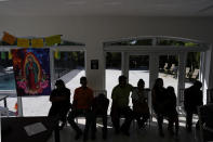 Mexican immigrants who have been unable to obtain work permits after living and working for years or even decades in the U.S., meet with activist Nora Sandigo and journalists, Tuesday, Nov. 7, 2023, in Miami. (AP Photo/Rebecca Blackwell)