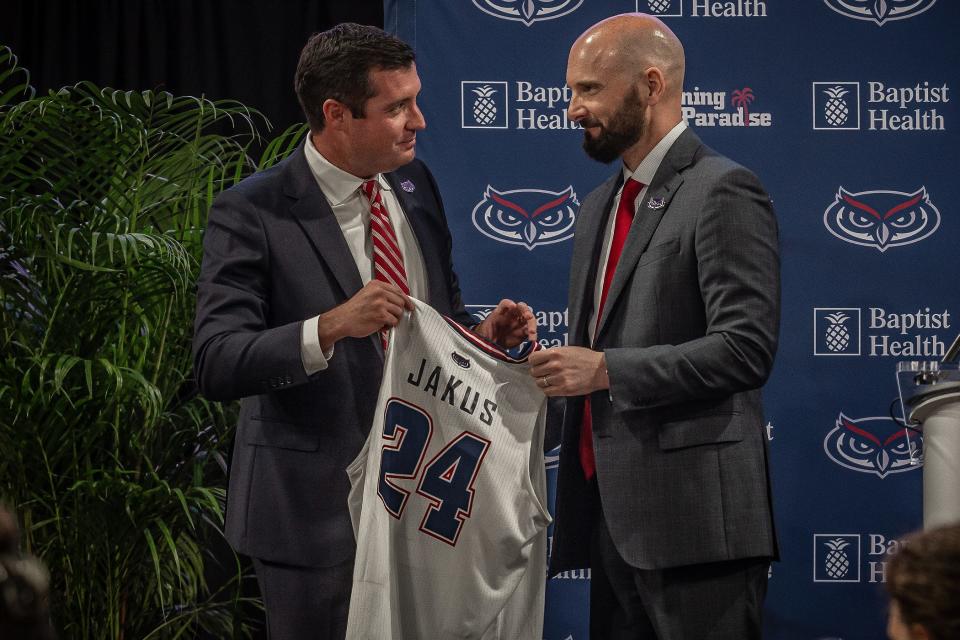 Brian White, Florida Atlantic University Vice President and Director of Athletics, stands with new head men's basketball coach John Jakus during an FAU press conference at Eleanor R. Baldwin Arena on campus in Boca Raton, Fla., on March 29, 2024.