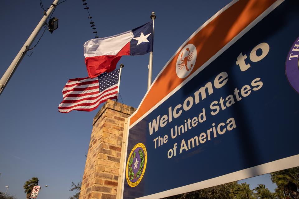 The U.S. and Texas flags fly near the U.S.-Mexico border on February 24, 2021 in Brownsville, Texas.