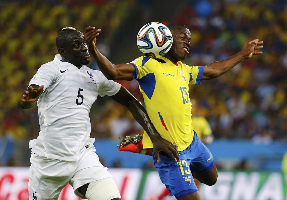 Ecuador's Enner Valencia (R) fights for the ball with France's Mamadou Sakho during their 2014 World Cup Group E soccer match at the Maracana stadium in Rio de Janeiro June 25, 2014. REUTERS/Kai Pfaffenbach (BRAZIL - Tags: SOCCER SPORT WORLD CUP TPX IMAGES OF THE DAY)