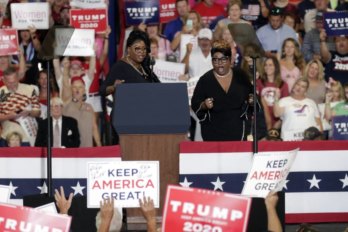 (L to R) Lynnette Hardaway and Rochelle Richardson, known as Diamond and Silk at the podium during a rally on Sept. 9, 2019 before then-President Donald Trump spoke in Fayetteville, North Carolina. (AP Photo/Chris Seward, File)