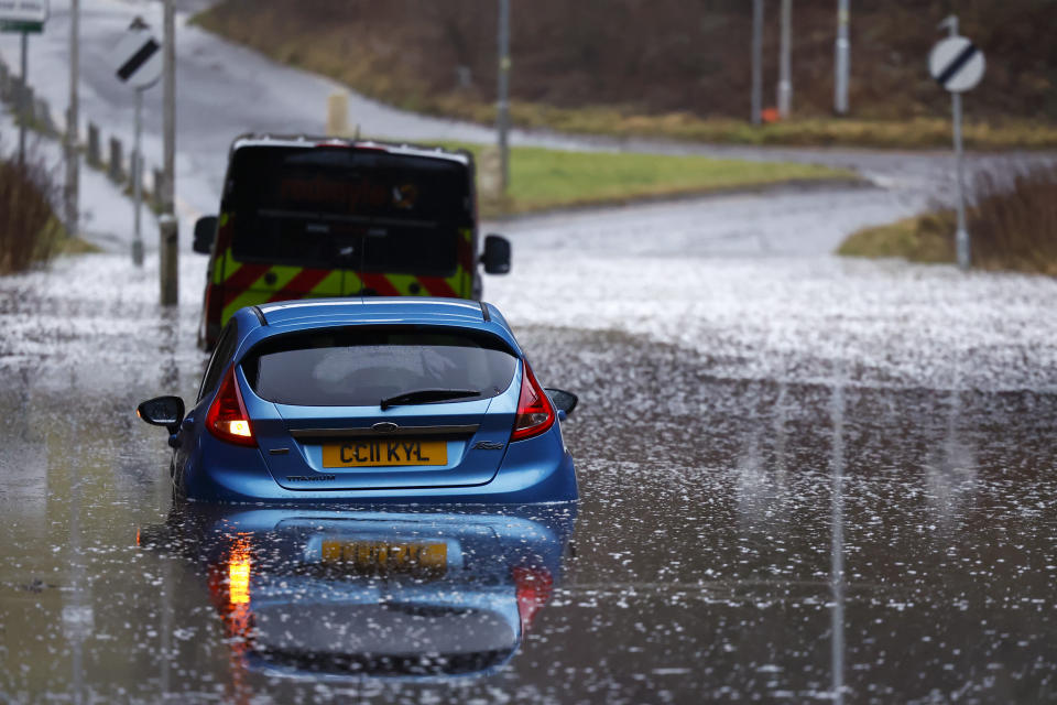 Vehicles stuck in flood water on Wednesday in Old Kilpatrick, Scotland. (Getty Images)