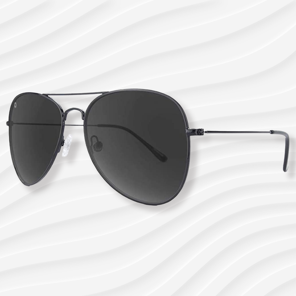the knockaround mile highs aviator sunglasses on a white wavy background