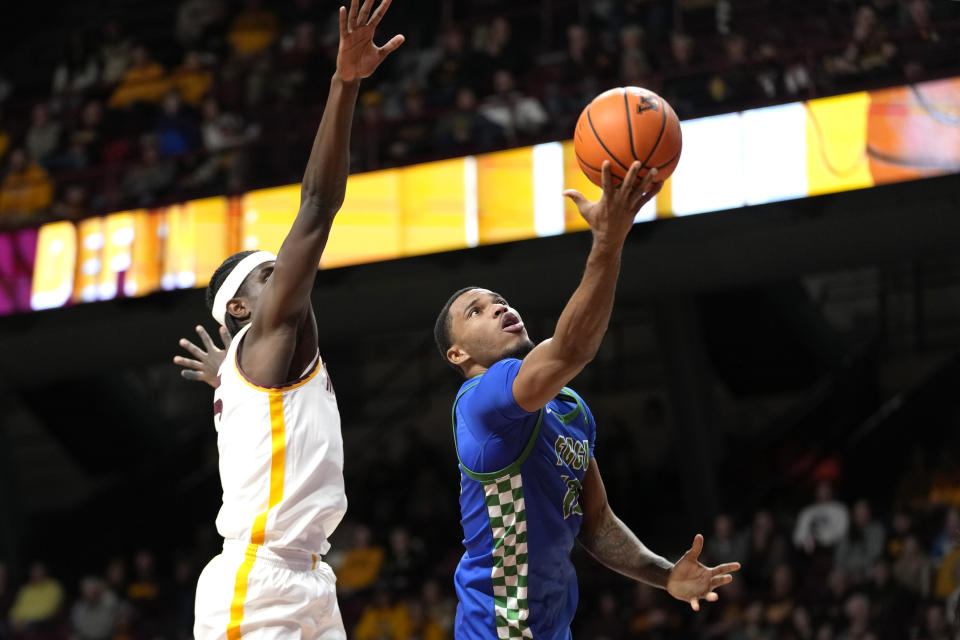 Florida Gulf Coast guard Franco Miller Jr., right, goes up for a shot as Minnesota forward Isaiah Ihnen defends during the second half of an NCAA college basketball game Saturday, Dec. 9, 2023, in Minneapolis. (AP Photo/Abbie Parr)