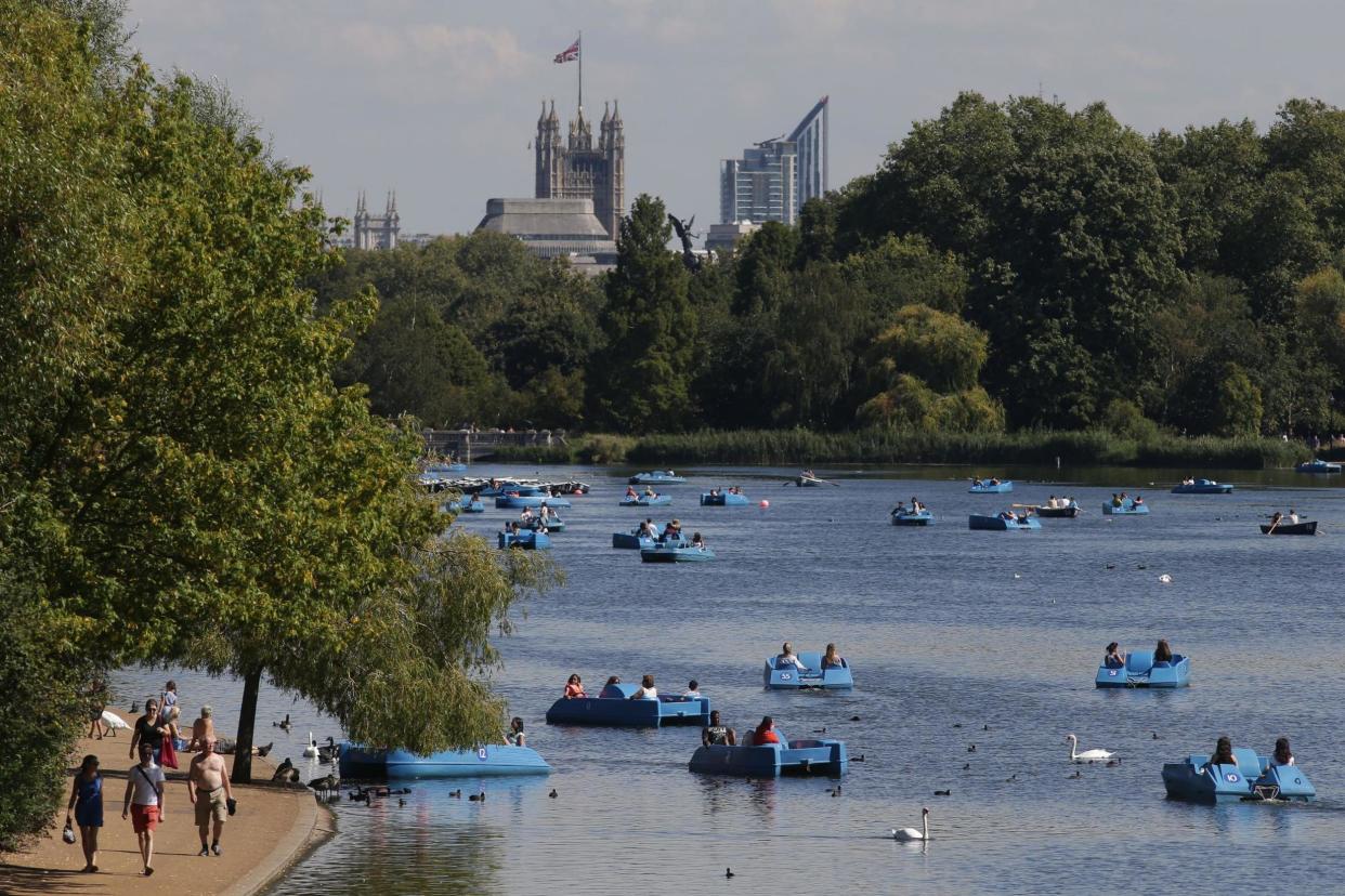 People using pedalos and row boats on the Serpentine in Hyde Park, London, during a hot and sunny day: PA Archive/PA Images