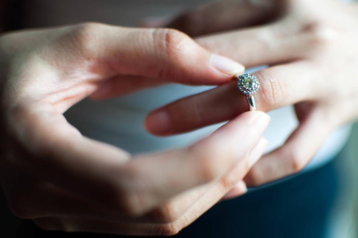 A woman wears her engagement ring to her left index finger