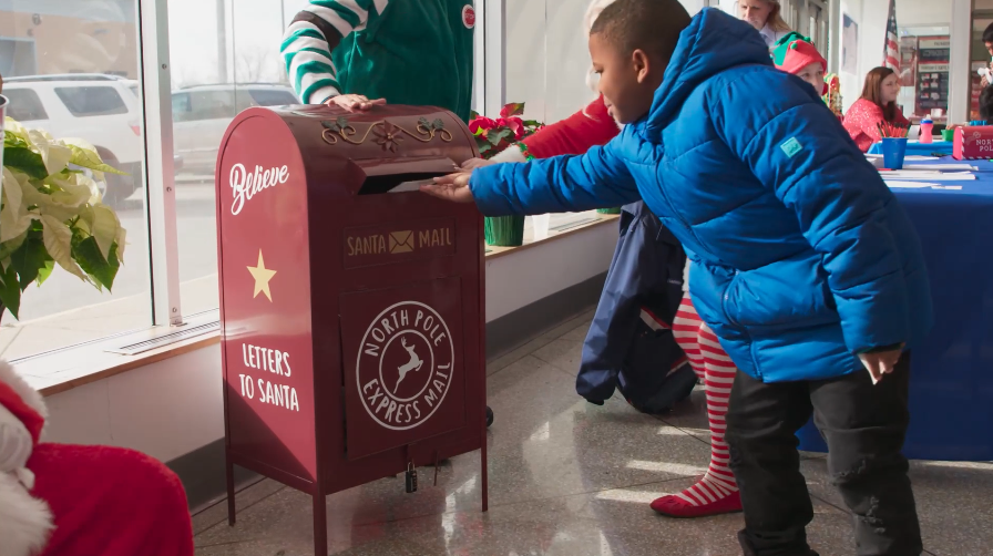 A child mails off a letter to Santa in a scene from Dana Nachman's "Dear Santa" documentary.