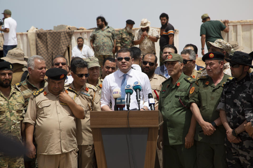 Libyan Prime Minister Prime Minister Abdul Hamid Dbeibah attends the reopening of the road between the cities of Misrata and Sirte Sunday, June 20, 2021. Libya's interim authorities reopened on Sunday the Mediterranean coastal highway linking the country's long-divided eastern and western cities, in the latest bid to reunite the territories after years of civil war. (AP Photo/Yousef Murad)