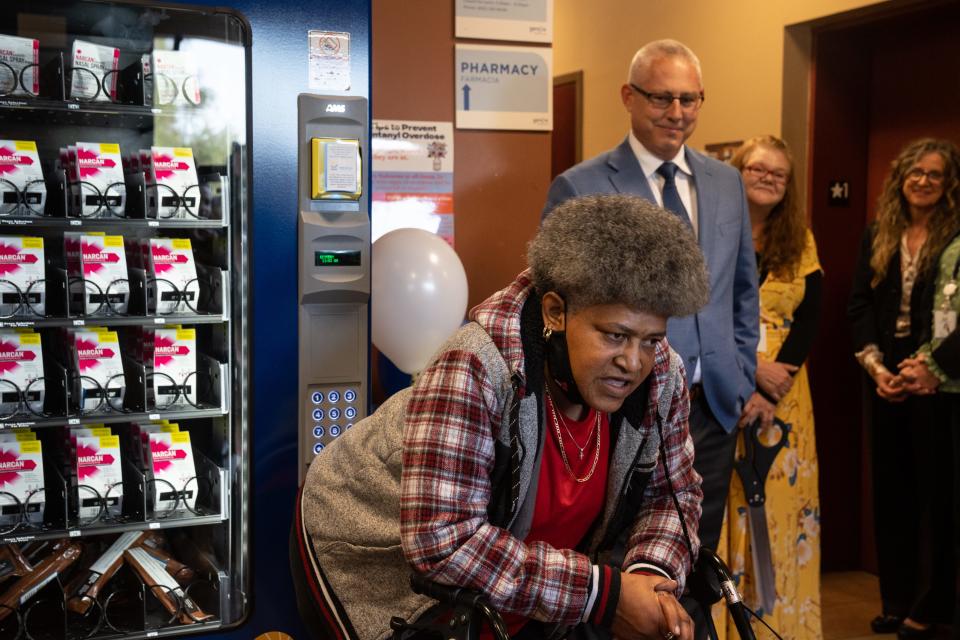 Gertrude Gross (client, front) speaks during the unveiling of a Narcan vending machine, Jan. 19, 2024, at Valle del Sol, 1209 S. First Ave., Phoenix, Arizona. Looking on is Mike Renaud (standing left, CEO Valle del Sol).