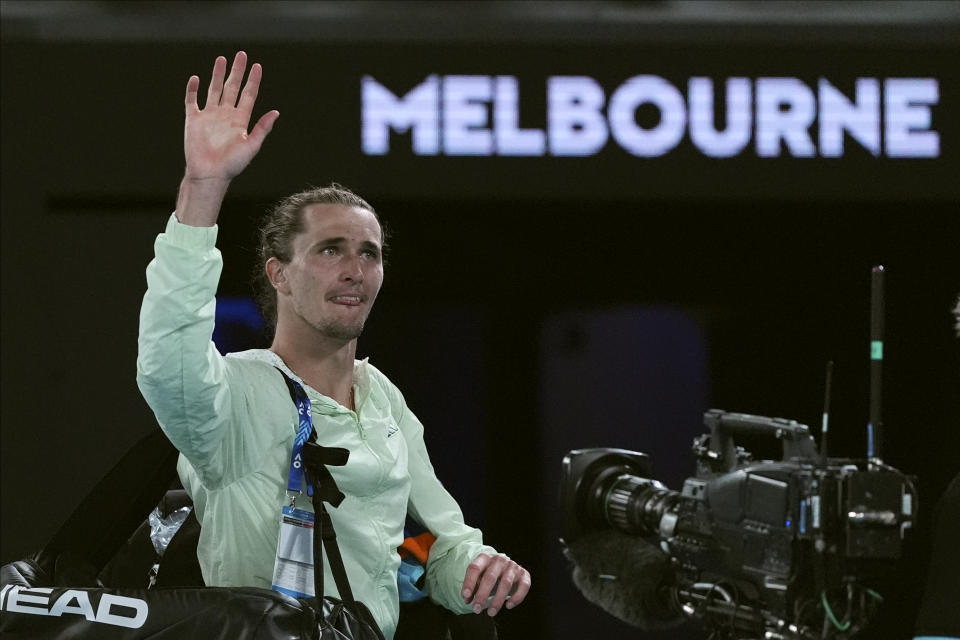 Alexander Zverev of Germany waves after defeating Carlos Alcaraz of Spain in their quarterfinal match at the Australian Open tennis championships at Melbourne Park, Melbourne, Australia, early Thursday, Jan. 25, 2024. (AP Photo/Andy Wong)
