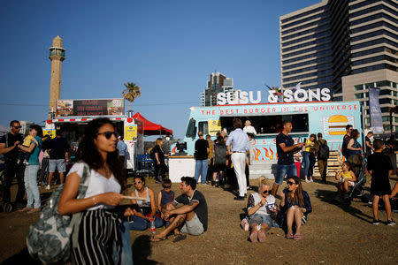 The minaret of the Hassan Bek Mosque is seen as people visit the Eurovision Village, an area dedicated to fans of the 2019 Eurovision Song Contest, in Tel Aviv, Israel May 14, 2019. REUTERS/Corinna Kern