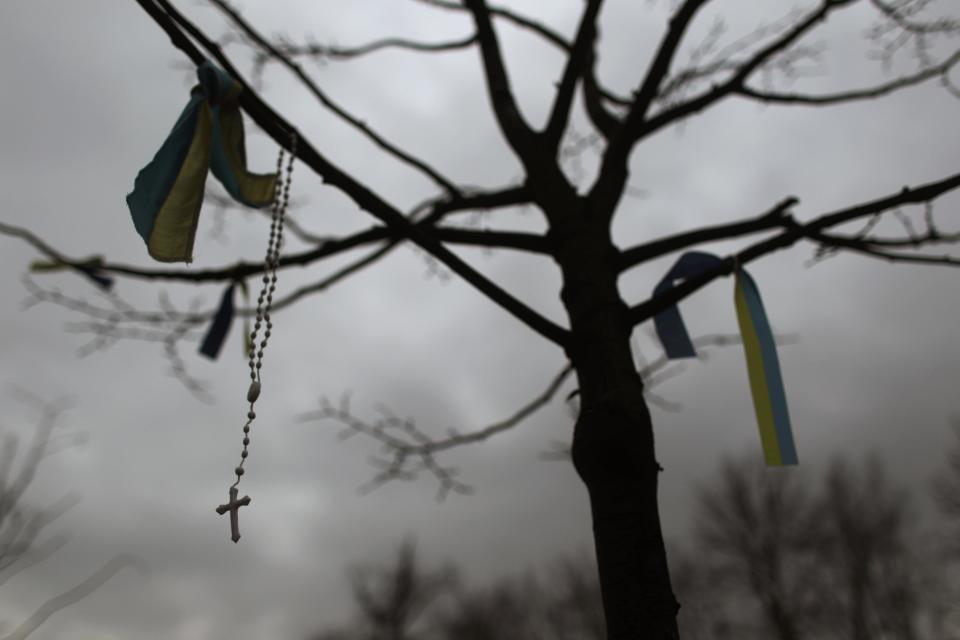 A rosary beads hangs on a tree in Kiev's Independence Square, the epicenter of the country's current unrest, Ukraine, Tuesday, Feb. 25, 2014. The Ukrainian parliament on Tuesday delayed the formation of a new government, reflecting political tensions and economic challenges following the ouster of the Russia-backed president. Parliament speaker Oleksandr Turchinov, who was named Ukraine's interim leader after President Viktor Yanukovych fled the capital, said that a new government should be in place by Thursday, instead of Tuesday, as he had earlier indicated. (AP Photo/Marko Drobnjakovic)