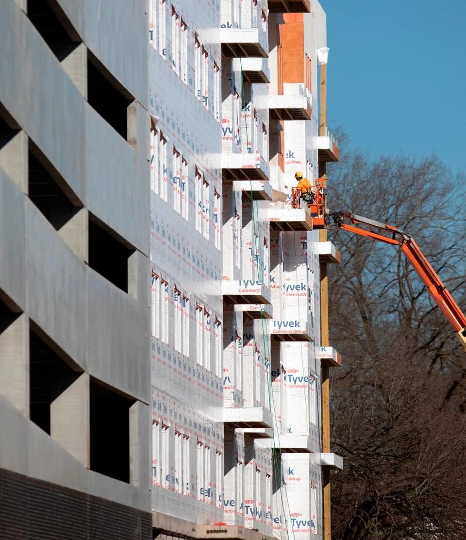 Crews work at a construction site for an apartment building at 900 Willow Drive as development continues at University Place mall on Monday, Dec. 18, 2023, in Chapel Hill, N.C.