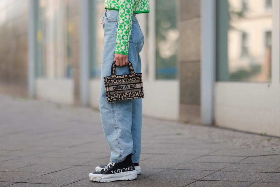 BERLIN, GERMANY - AUGUST 03: Sonia Lyson wearing Dior mini bag, green and white Zara cardigan, & other stories blue jeans and black Louis Vuitton sneakers on August 03, 2021 in Berlin, Germany. (Photo by Jeremy Moeller/Getty Images)