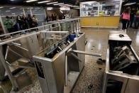 The subway ticket gates are seen destroyed after protests against the increase in the subway ticket prices in Santiago