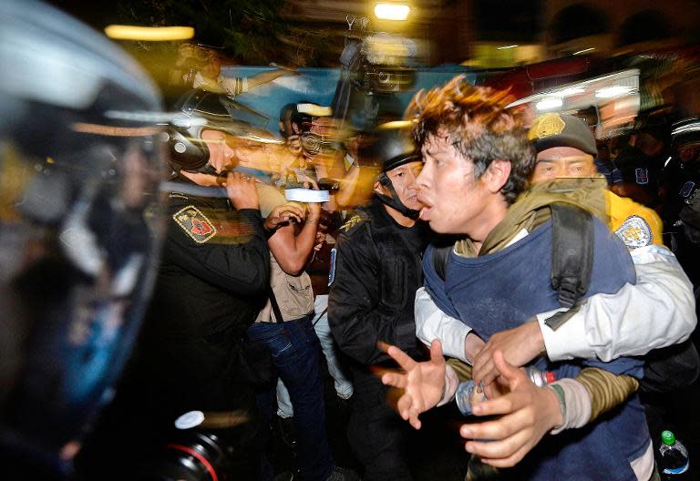 A student is arrested by police in Mexico City on February 26, 2015, as protesters demand justice and clarification for the disappearance of 43 students from Ayotzinapa