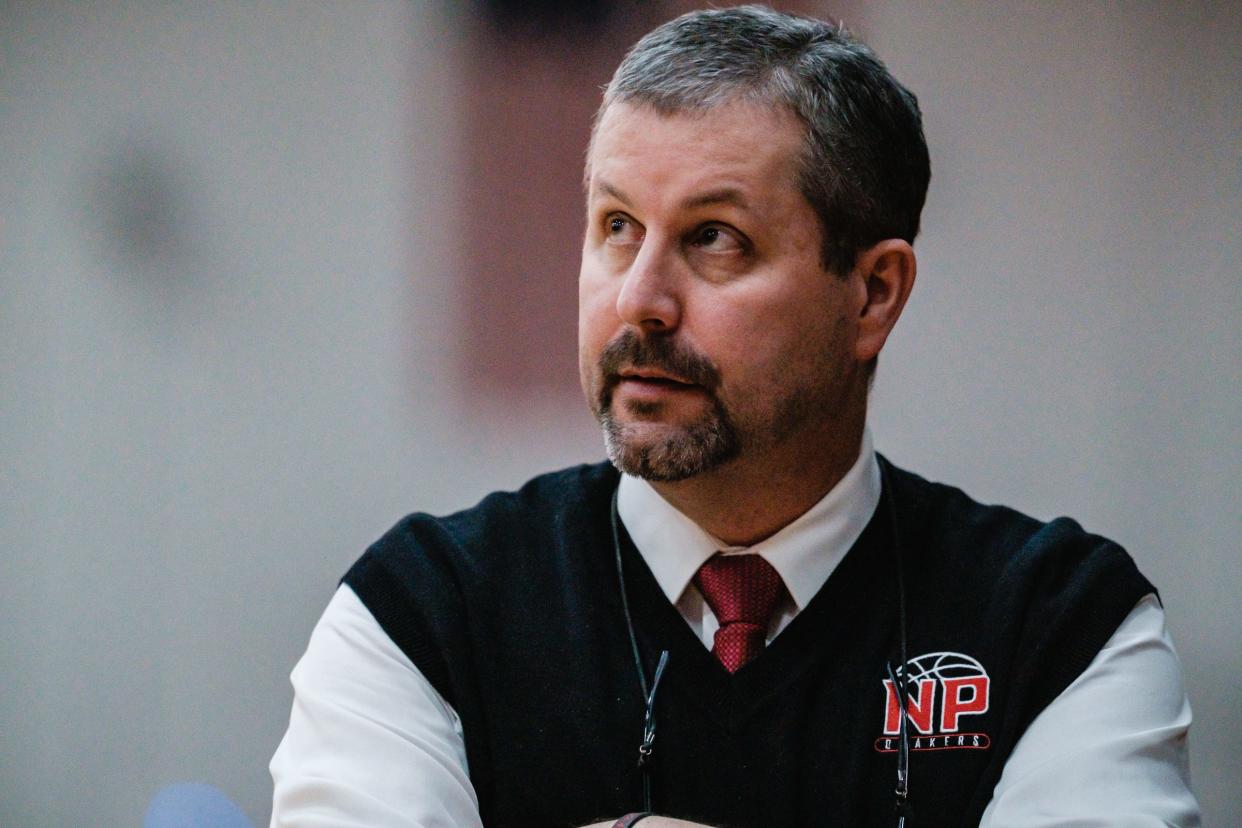 New Philadelphia head coach Matt Voll checks the clock during the matchup against Dover,